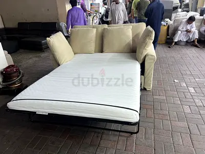 Beige 2-seater sofa bed with pull-out mattress