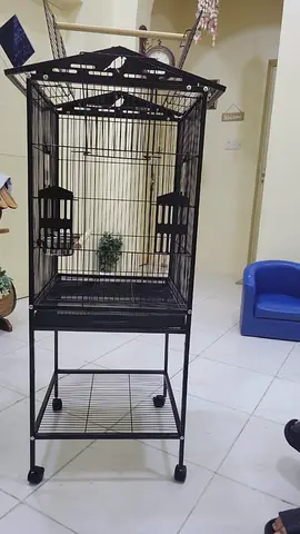 Large black metal bird cage on stand with wheels