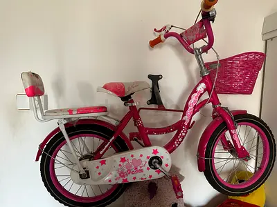 Pink girls' 16-inch bicycle with training seat and front basket