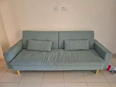Three-seater teal fabric sofa in good condition
