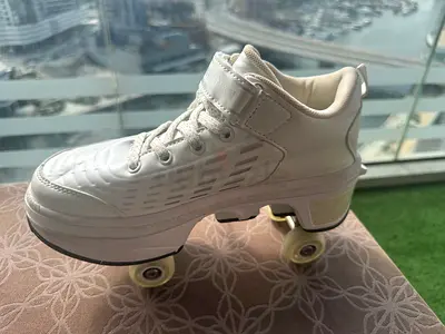 White Quad Roller Skates - Size 37 Made in USA , brand Risea, very light Use. Retractable wheels.