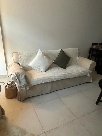 Ikea sofa with blanket and cushions