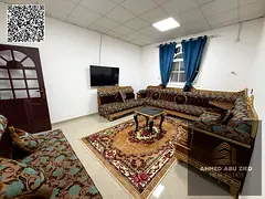 Furnished 1BR hall in Al Rawda 3 near Dubai exit, separate kitchen, spacious layout; monthly rent AE