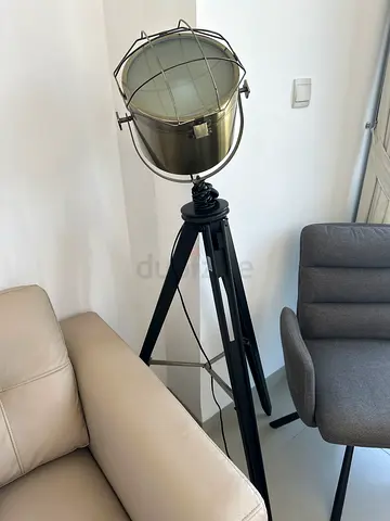 Industrial-style tripod floor lamp with metal cage shade