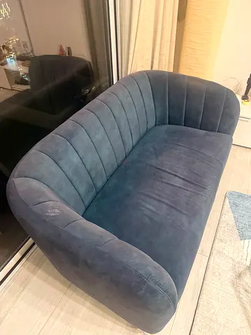 Blue velvet 2-seater sofa in good condition