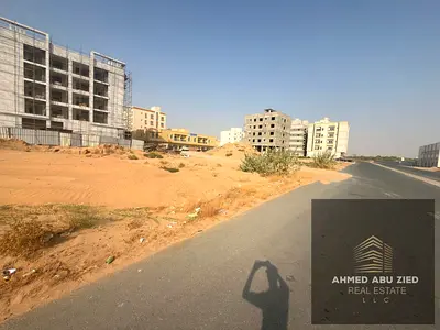 Residential commercial land for sale in Al Alia Ajman, 400 sqm, G+4 permit, prime investment location near Tiger Project and main roads