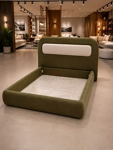 Green upholstered platform bed with padded headboard (queen/king base)