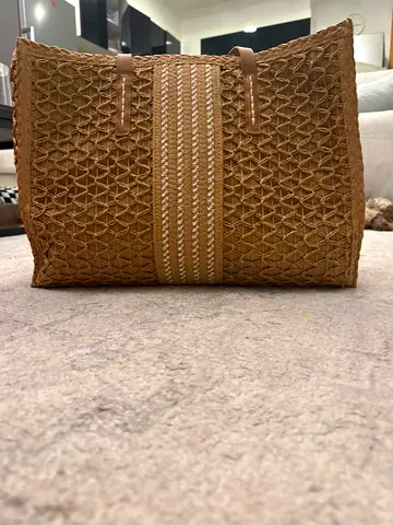 Large woven straw tote bag with leather handles
