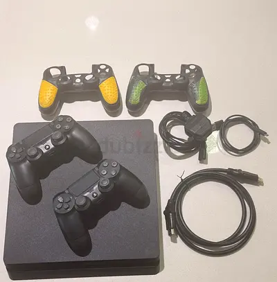 PlayStation 4 Slim with 2 DualShock controllers + 2 extra grips and cables