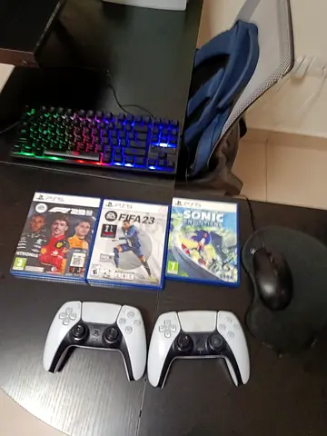 PS5 with controllers and games