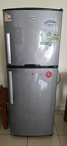 Used double-door refrigerator in working condition - stainless finish