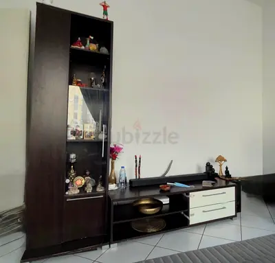 Dark wood entertainment center with glass display cabinet and drawers