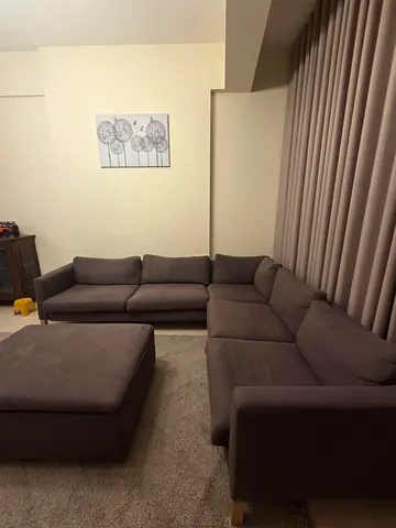 Large L-shaped brown fabric corner sofa with ottoman - good condition