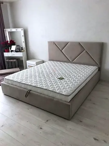 Beige upholstered double bed modern design
