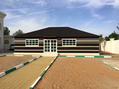 Large traditional majlis tent / outdoor seating structure.