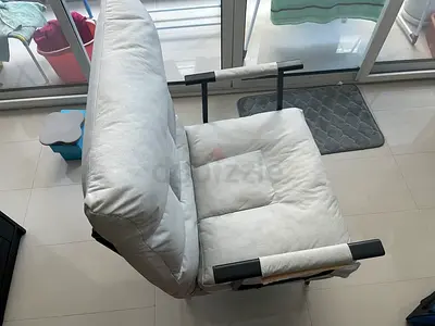 White cushioned lounge chair with armrests,foldable in 4 different positions as ease chair and bed