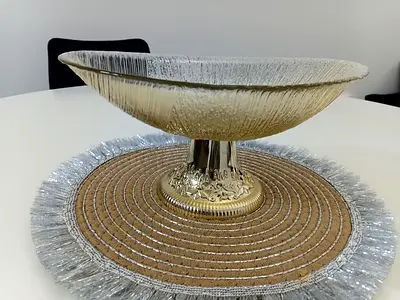 Decorative glass centerpiece bowl on metal pedestal