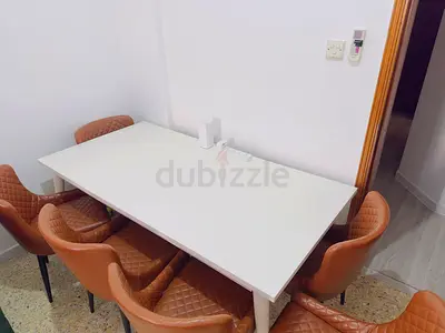Rectangular Dining Table with Brown Quilted Chairs