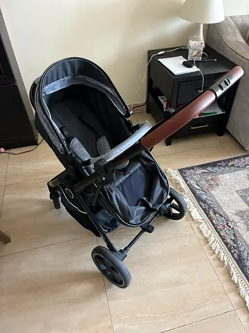 Lightly used compact pram stroller with reclining seat and storage basket