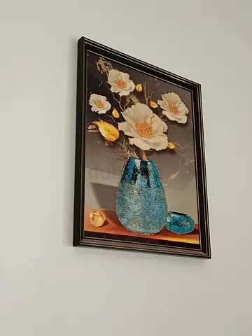 Framed floral painting with blue vase