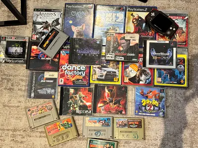 Mixed collection of retro consoles, handheld and PS2/PS3 games all working