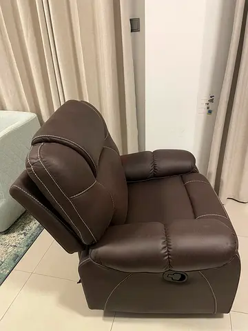 Brown leather swinger recliner armchair in good condition