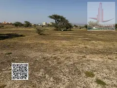 Two residential plots of land for sale in Ajman, Al Manama 4. The plots are corner lots on two stree