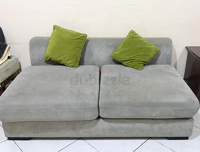 Light grey two-seater modular sofa with cushions