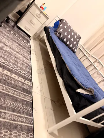 Single metal bed frame with bedside drawer and grey patterned rug