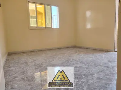 Annual Rent – 2BR & Living | Al Nuaimiya 1, Ajman. Spacious, 2 baths, central AC, open-view balcony, and fully new kitchen.
