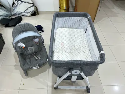 Grey bedside bassinet with changing pad and baby rocker set with music & vibration - gently used