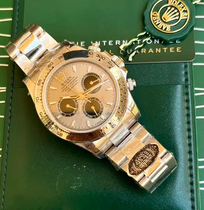 Rolex Cosmograph Daytona featuring a golden dial with contrasting black chronograph subdials