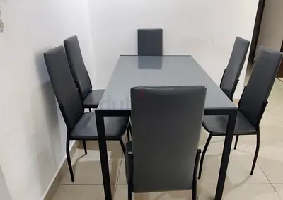 6-seater modern dining table with glass top and grey chairs from pan home