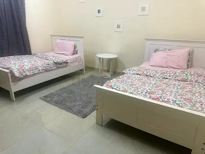 2 twin size white beds with free table.