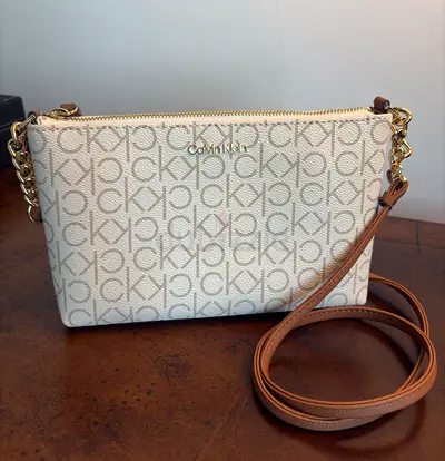 Calvin Klein beige monogram crossbody bag with gold chain strap