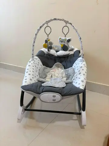 Gray baby rocker/bouncer with toy arch - gently used