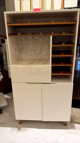 White wooden bar cabinet with wine rack and glass storage