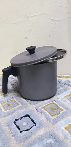 Oil container with  sieve for leftover oil and water bottles