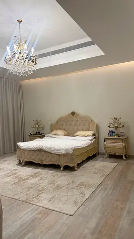 Super king size classic carved wooden bed with matching nightstands , dressing table and chandelier.