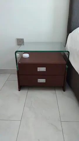 Glass-top bedside table with two drawers