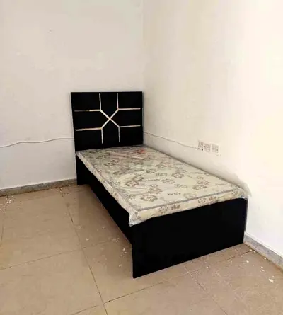 Single bed frame with black headboard and mattress