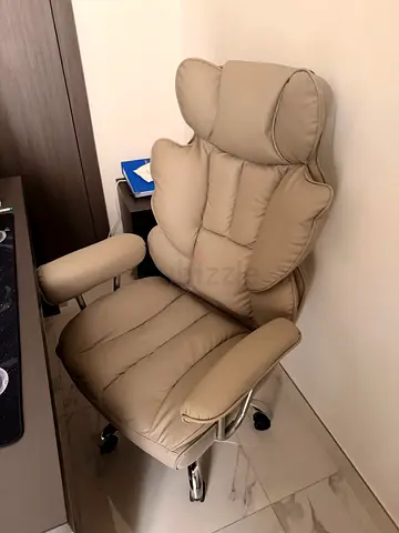 Beige leather swivel office chair with headrest - good condition