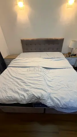 California King upholstered bed frame with tufted headboard and mattress