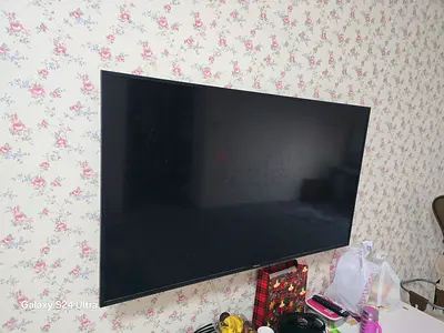 Hicense 55-inch LED TV mounted on wall - good condition