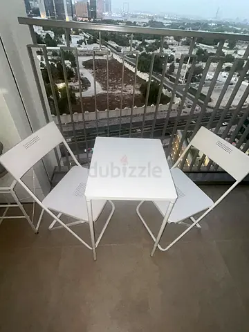 Compact white folding balcony table with 2 matching chairs - good condition