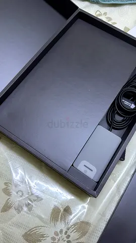 Like-new laptop charger and accessories in original box