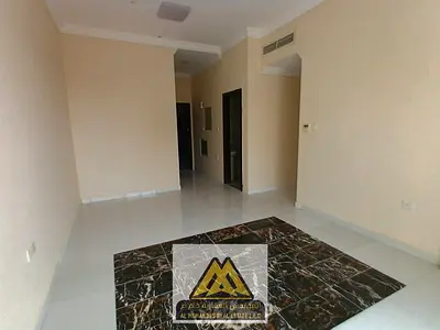 One-bedroom apartment with a living room for annual rent in Al Alia, Ajman. Features a balcony, central AC, 2 bathrooms, and free maintenance by the o