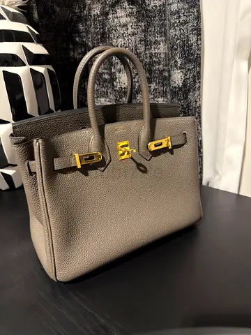 Women's grey leather tote handbag with gold hardware
