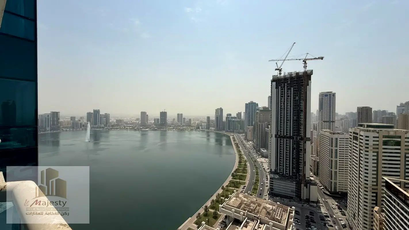 For sale: a unique apartment in Al-Dana Tower – Al Majaz 3, very high floor, luxurious finishing and fully renovated, 195 m² with a rear view of Khor