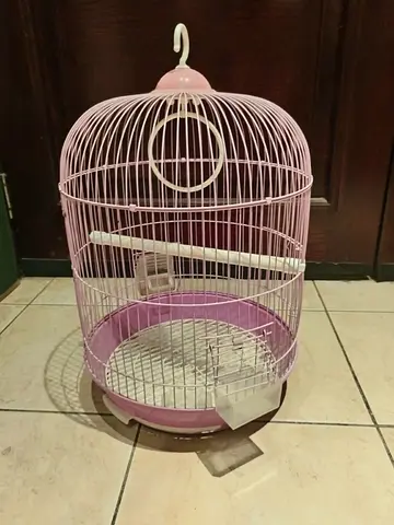 Pink round bird cage with perch and removable tray - good condition